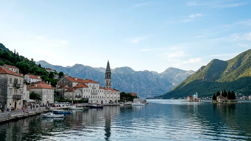 Perast's stone waterfront palaces and bell tower beside the calm Bay of Kotor